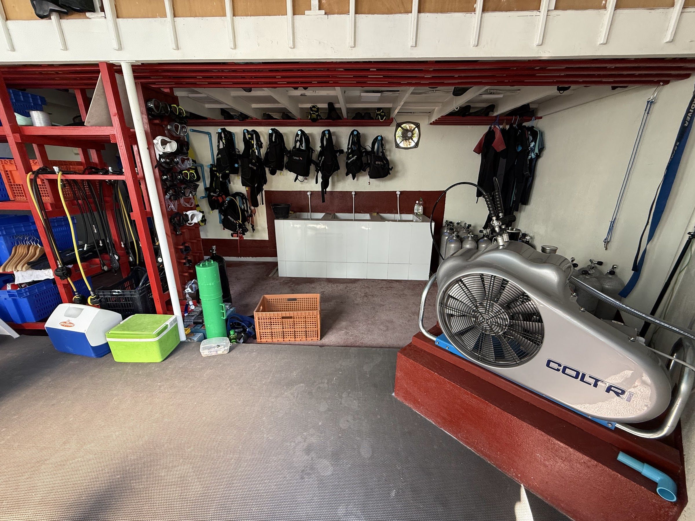 Dive Club Buoyancy equipment room with compressor
